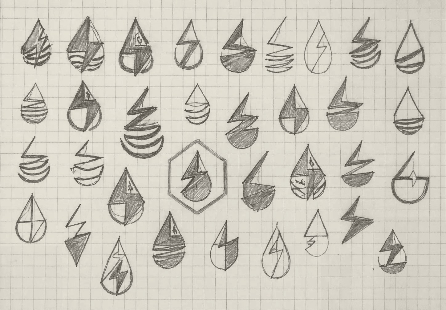 A grid of pencil sketches exploring droplet, flame and lightning-bolt marks